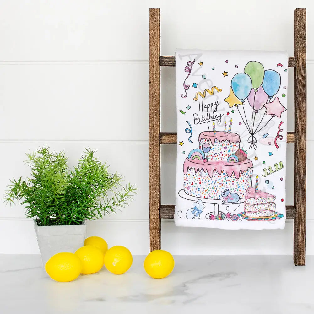 Happy Birthday Cake dish towel hanging in the kitchen