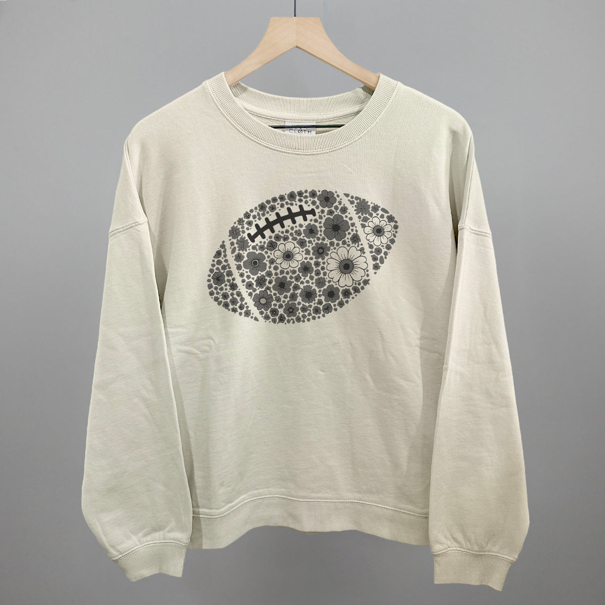 Grey floral football design shown in bone