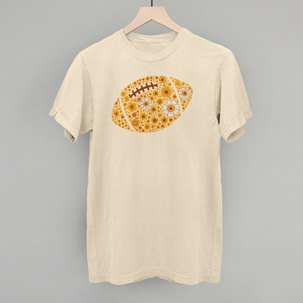 Yellow floral football design on an ivory Comfort Colors tee