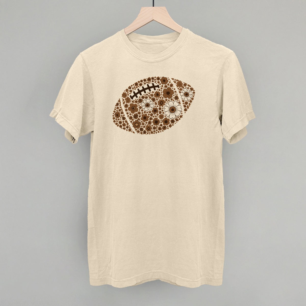 Brown floral football design on an ivory Comfort Colors tee
