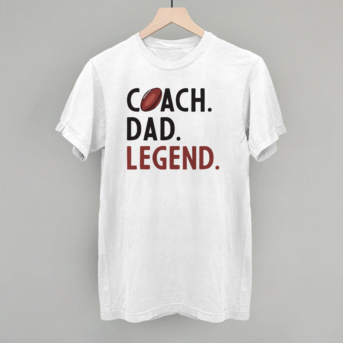 Coach Dad Legend football design on a white Comfort Colors tee