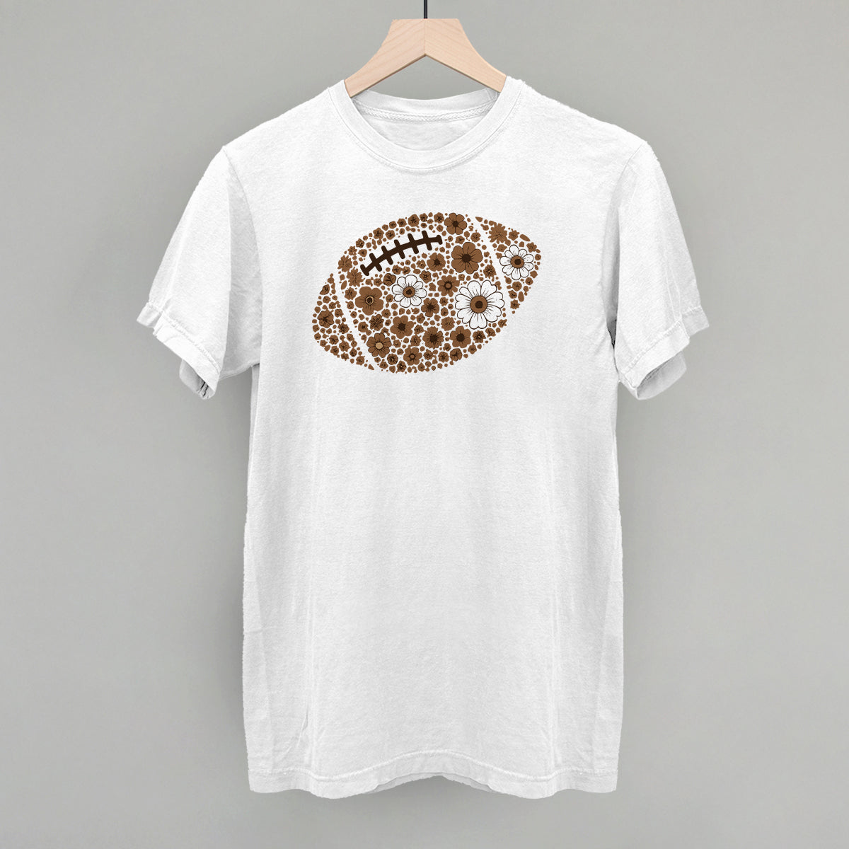 Brown floral football design on a white Comfort Colors tee