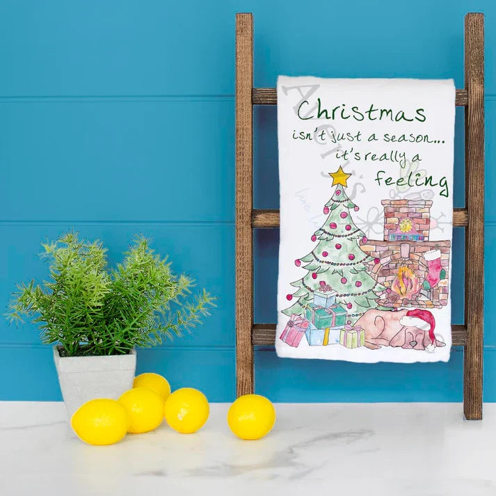 Christmas is a Feeling dish towel hanging in the kitchen
