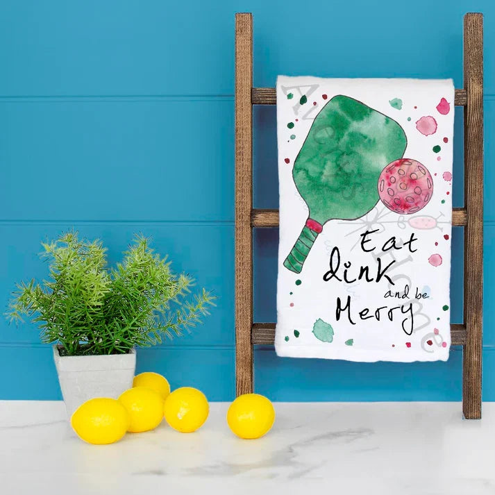 Eat, Dink, and Be Merry dish towel hanging in the kitchen