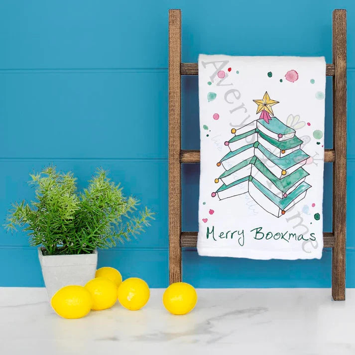 Merry Bookmas dish towel hanging in the kitchen