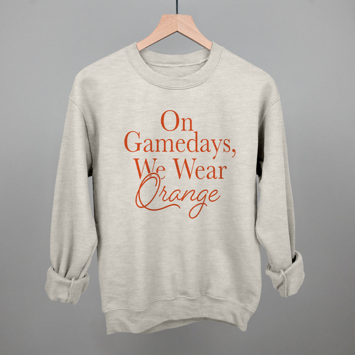 On Gamedays We Wear Orange design on an oatmeal crewneck sweatshirt