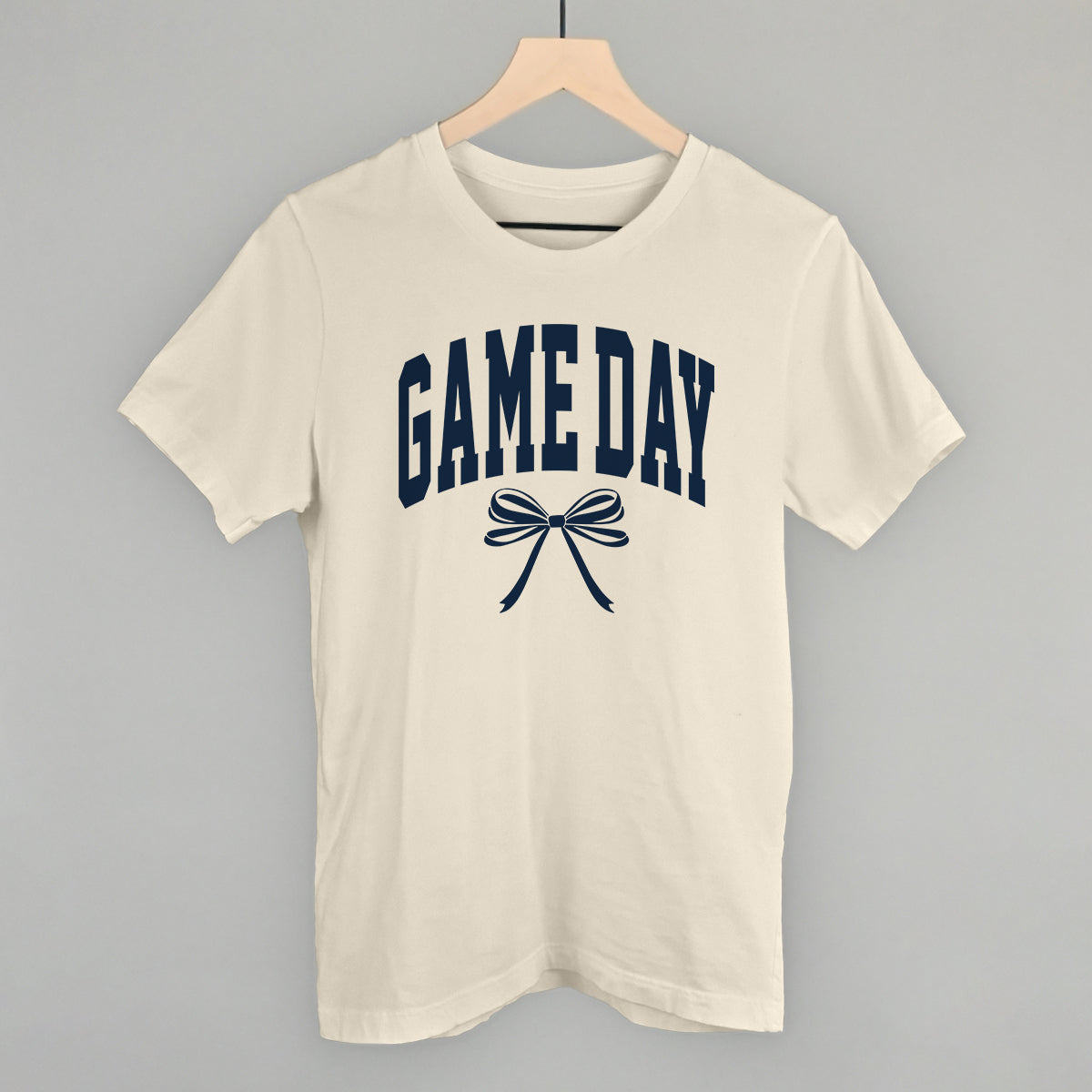 Game Day arch and bow design on a natural cotton tee