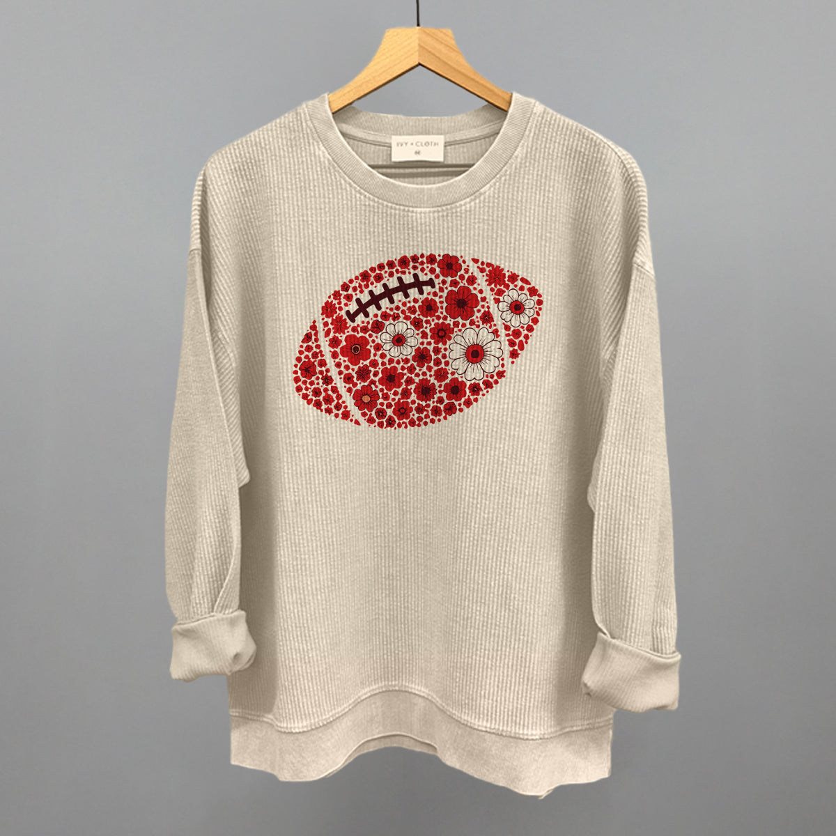 Red floral football design on a moonbeam oversized corded crew
