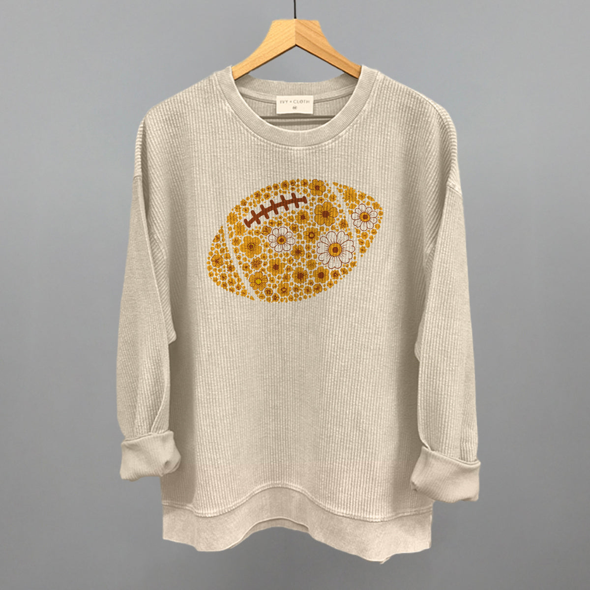 Yellow floral football design on a moonbeam oversized corded crew