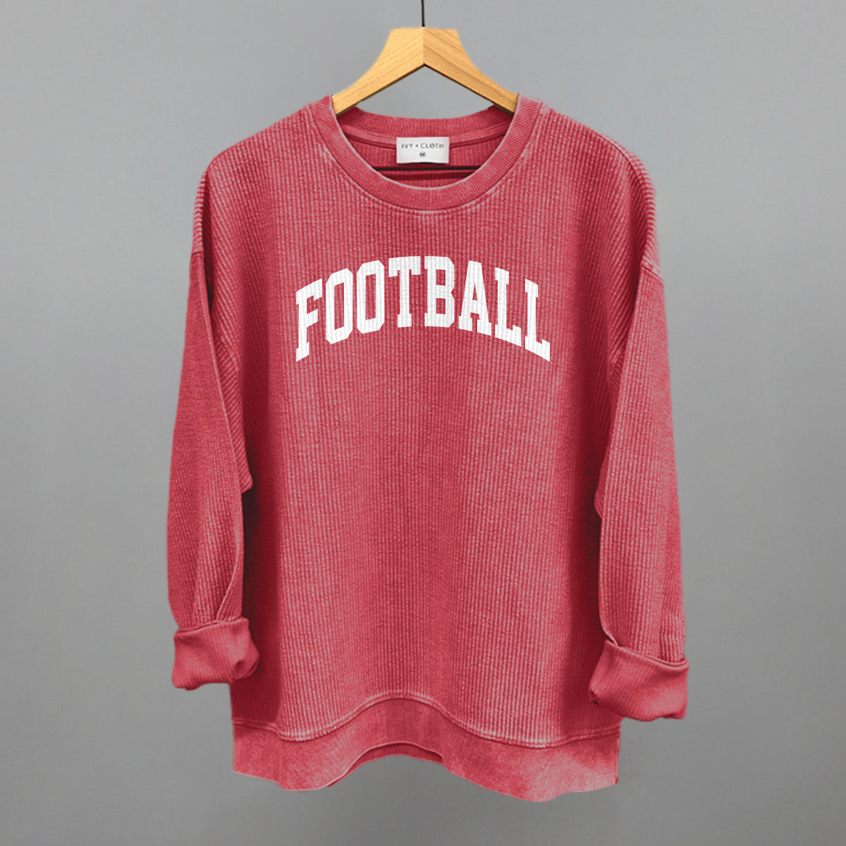 Football arch in white print on a red oversized corded crew