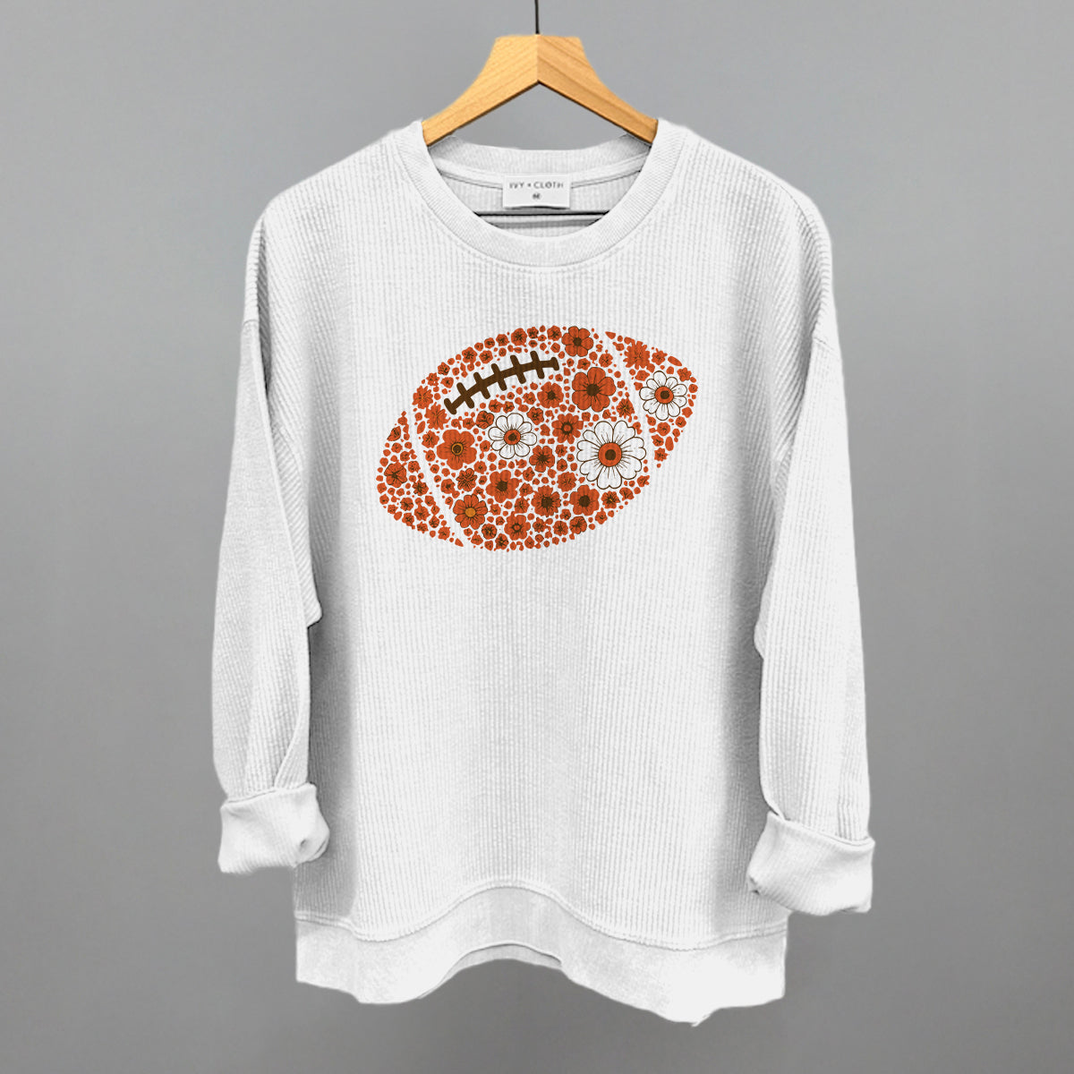Orange floral football design on a white oversized corded crew