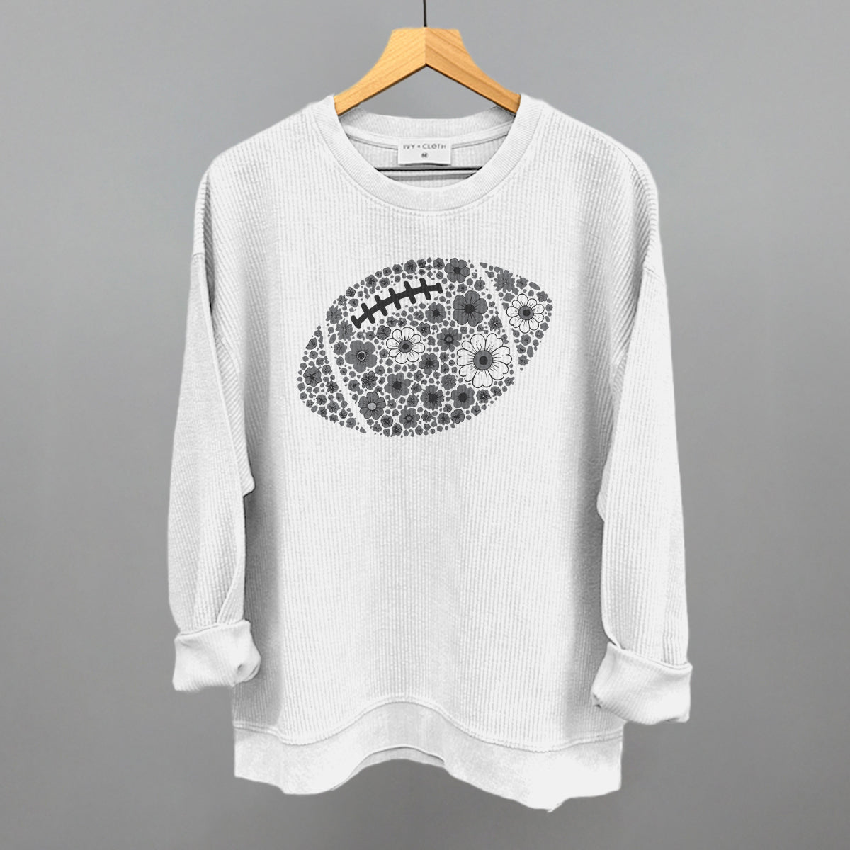 Grey floral football design on a white oversized corded crew