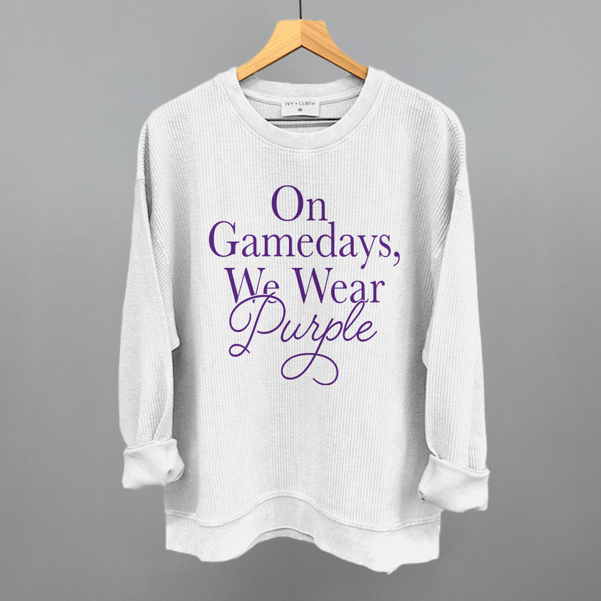 On Gamedays We Wear Purple design on a white oversized corded crew