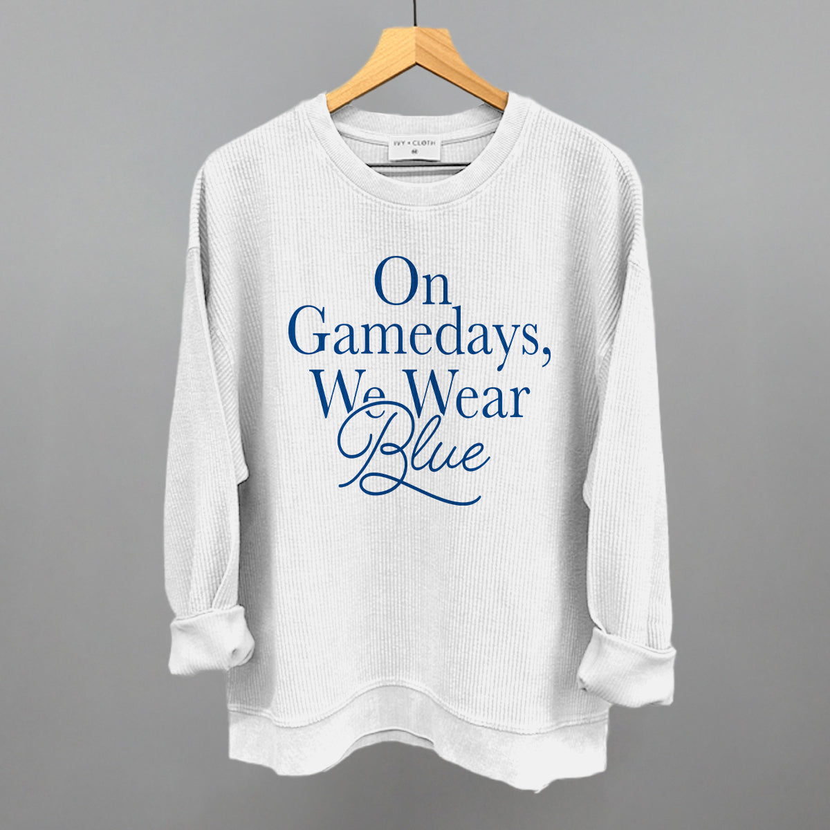 On Gamedays We Wear Blue design on a white oversized corded crew
