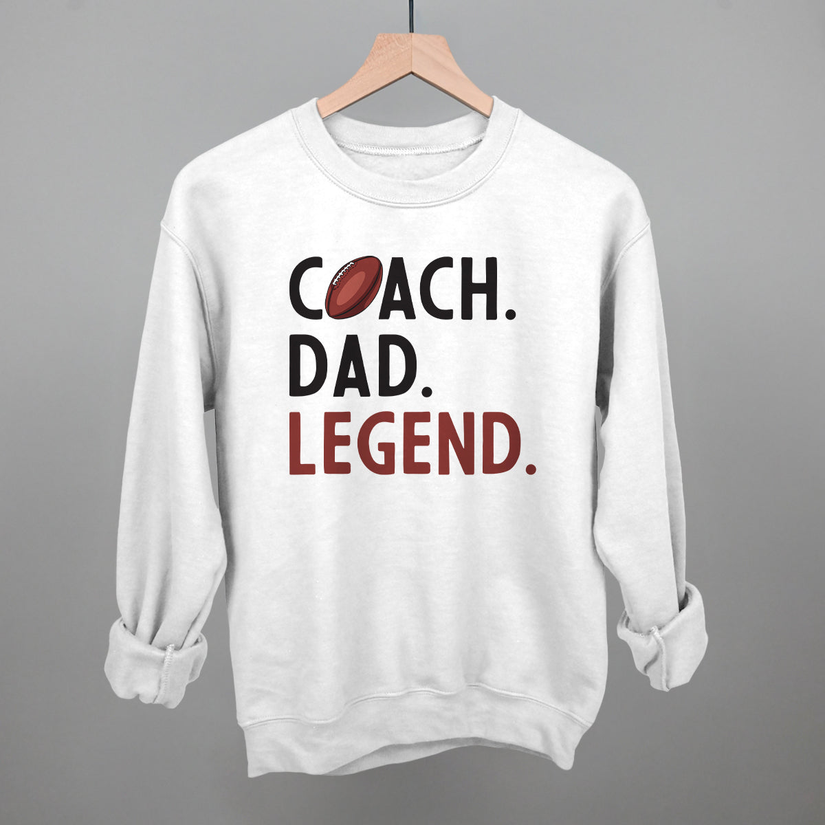 Coach Dad Legend football design on a white fleece crewneck sweatshirt