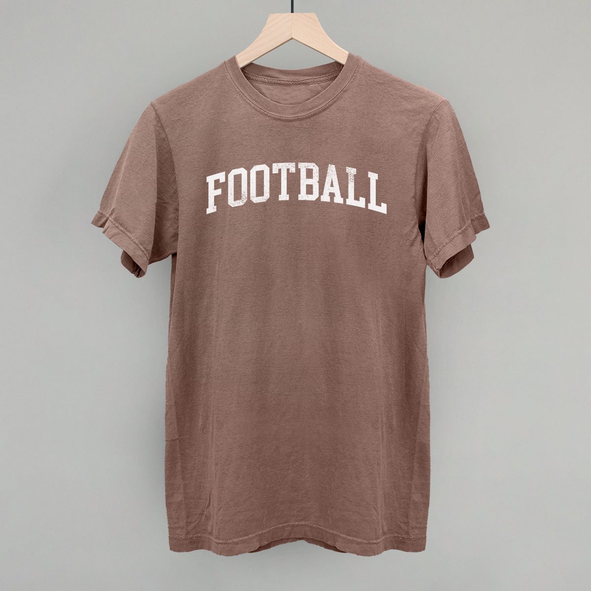 Distressed collegiate football design on an espresso Comfort Colors tee