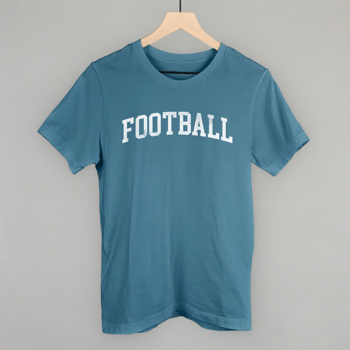Distressed collegiate football design on a steel blue cotton tee