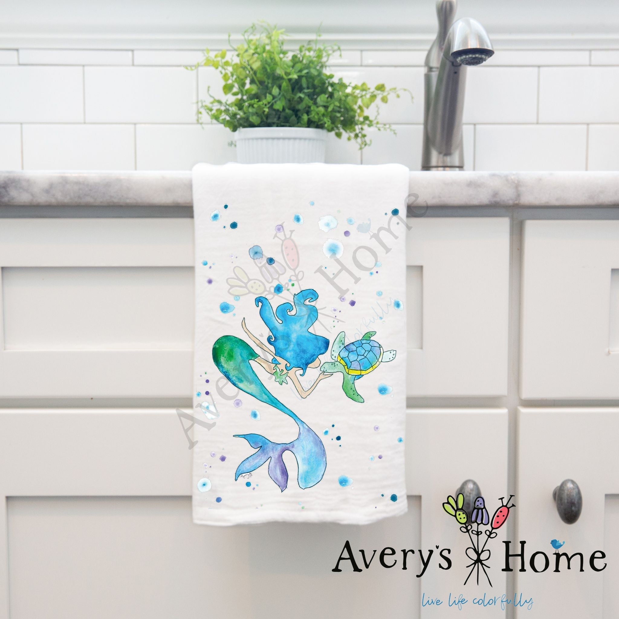 Mermaid and Turtle dish towel hanging in the kitchen
