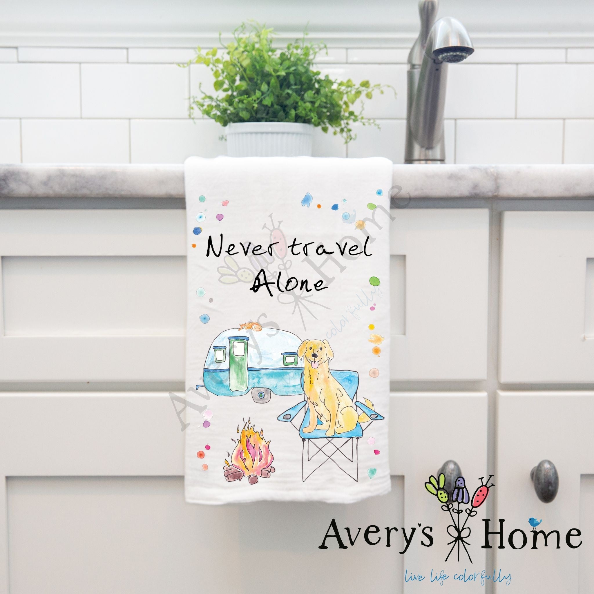 Never Travel Alone dish towel hanging in the kitchen