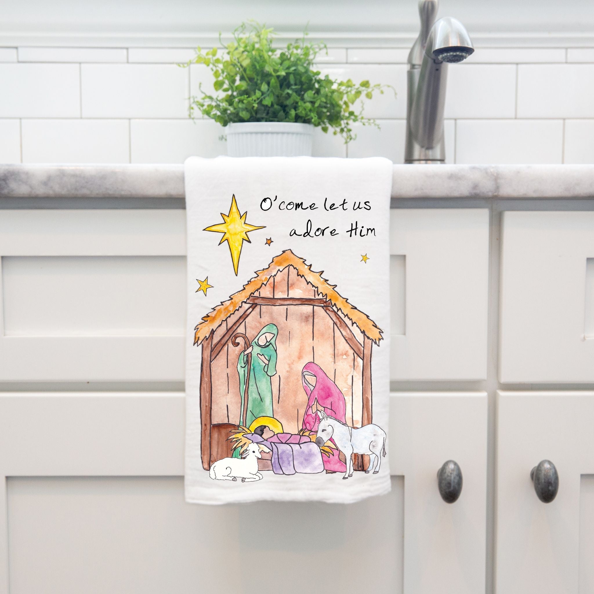Christmas Nativity dish towel hanging by kitchen sink