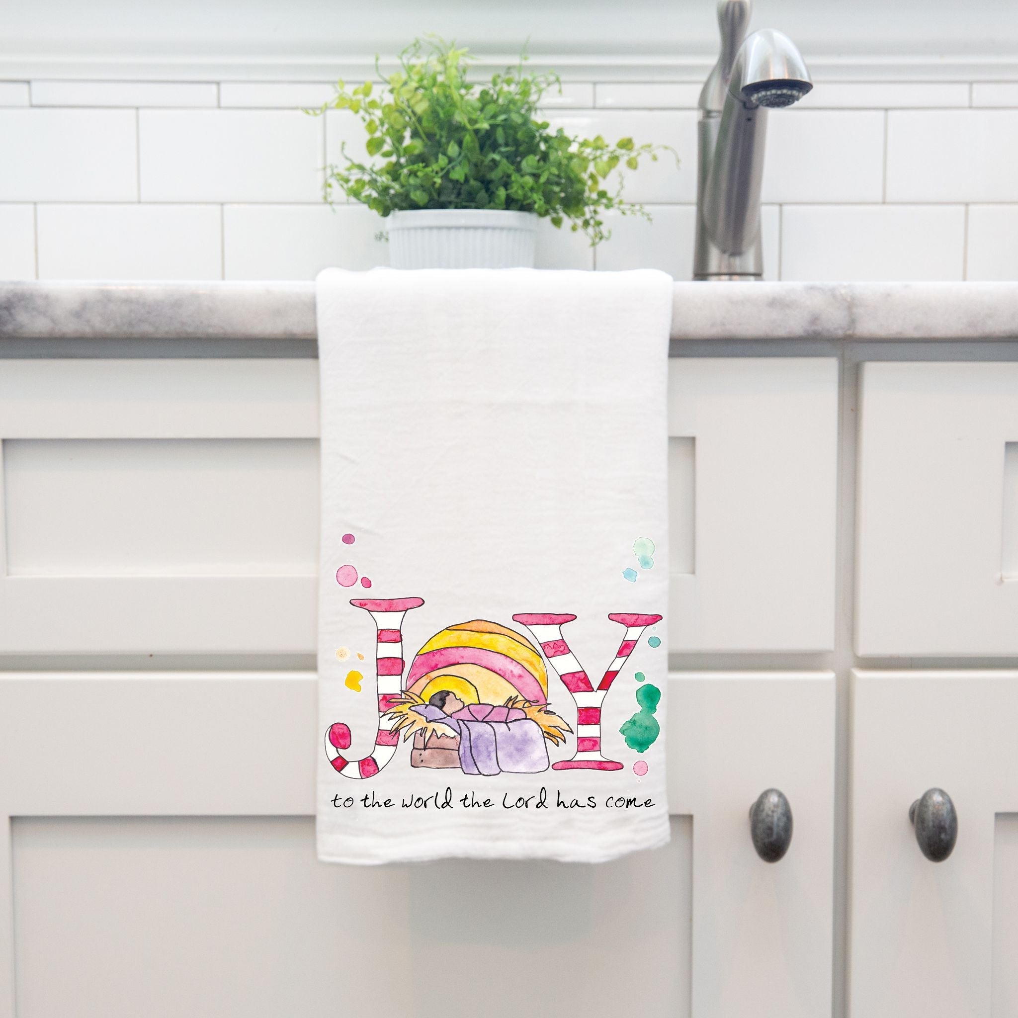Christmas Nativity Joy dish towel hanging by kitchen sink