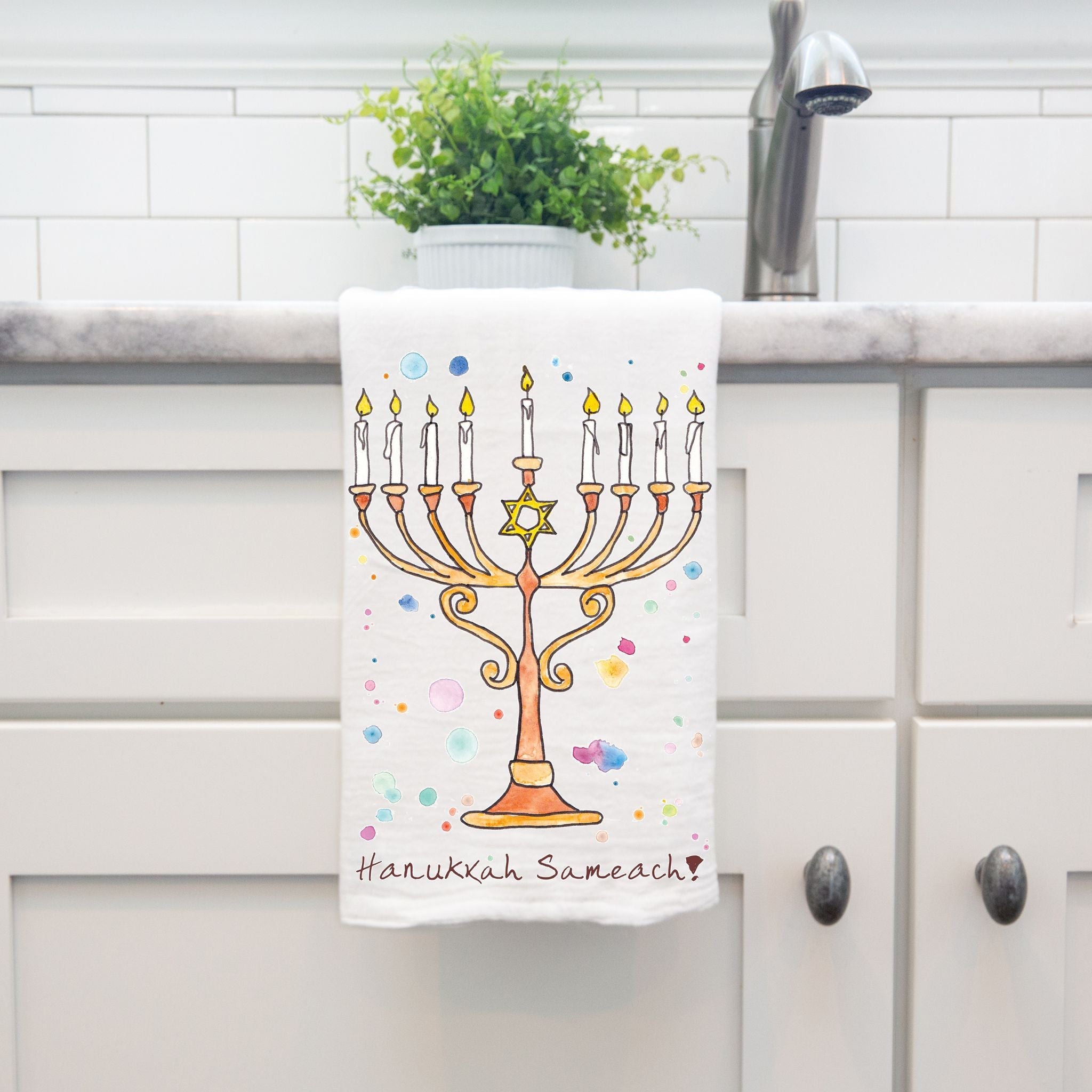 Happy Hanukkah dish towel hanging by kitchen sink