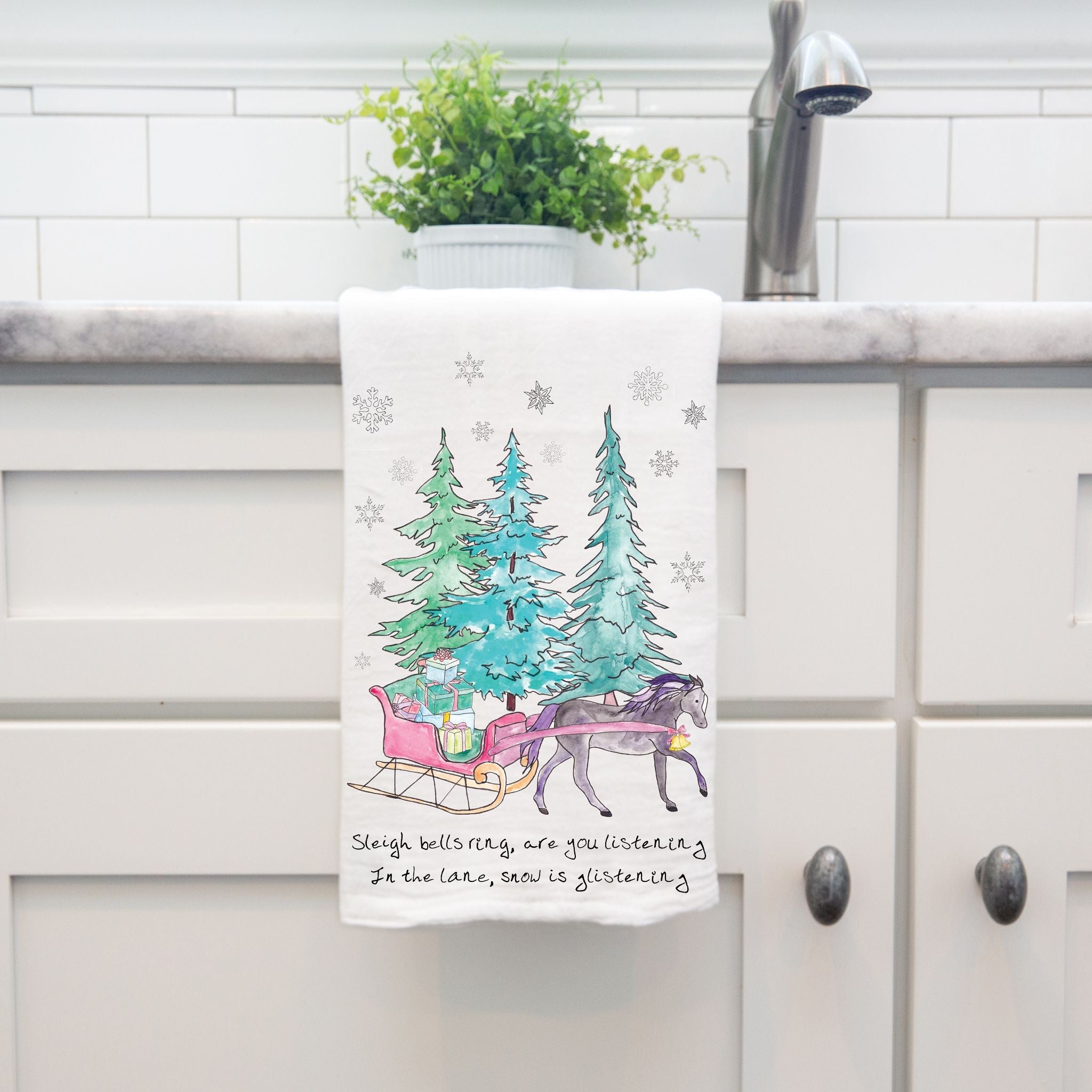 Christmas Horse and Sleigh Ride dish towel hanging in the kitchen