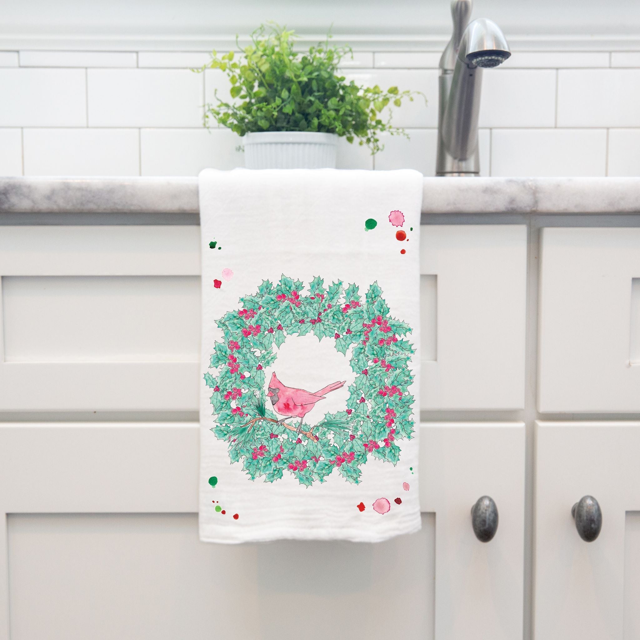 Cardinal Christmas Wreath dish towel hanging in the kitchen