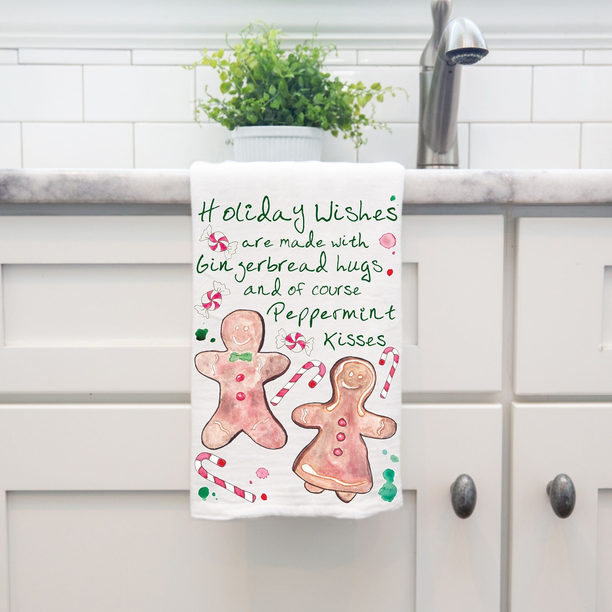Christmas Peppermint Kisses dish towel hanging by kitchen sink