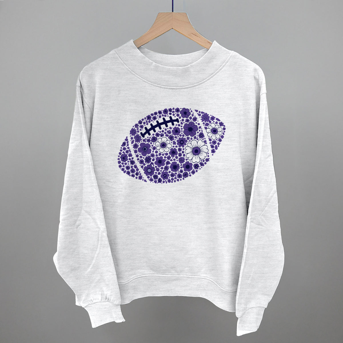 Purple floral football design on an ash French terry mockneck