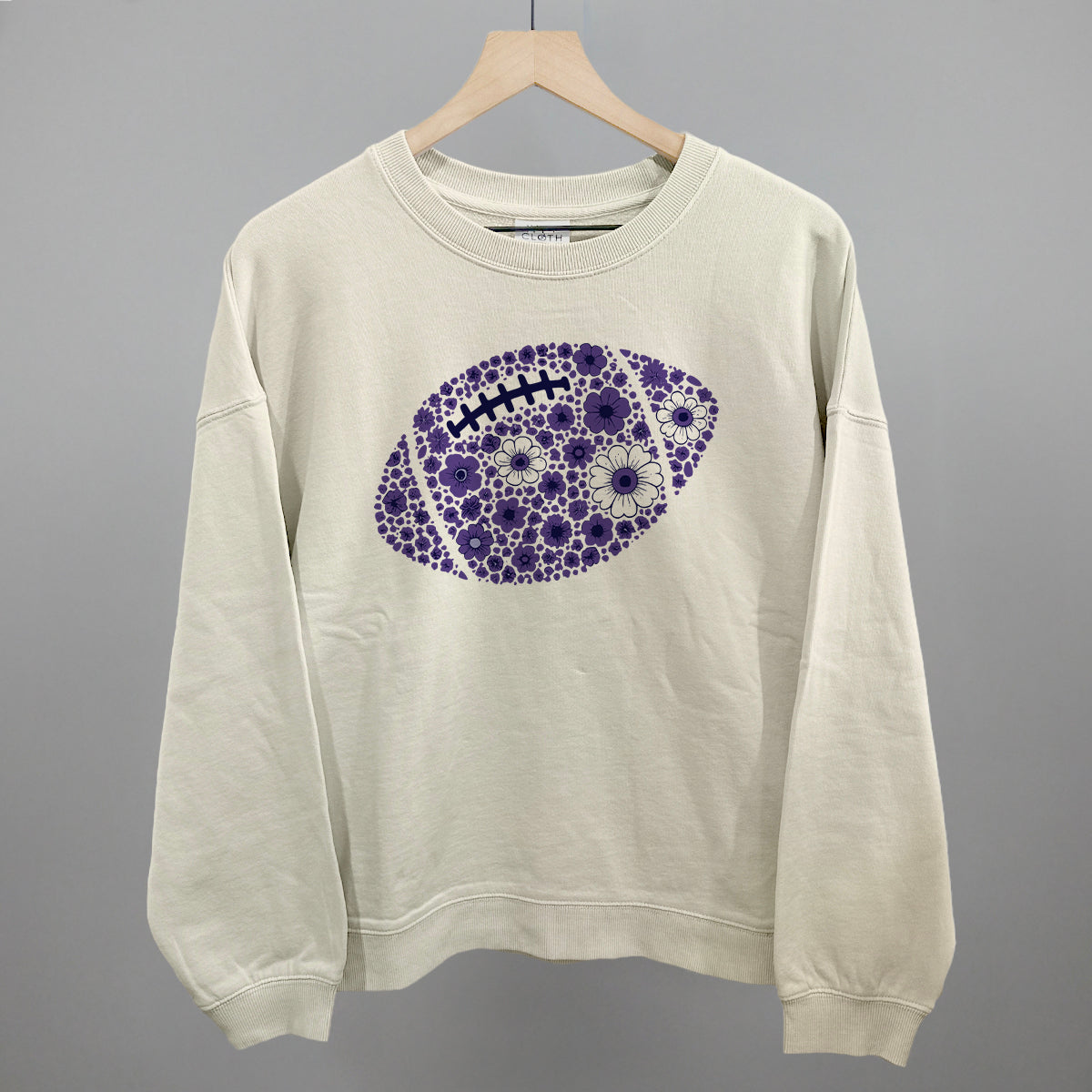 Purple floral football design shown in bone