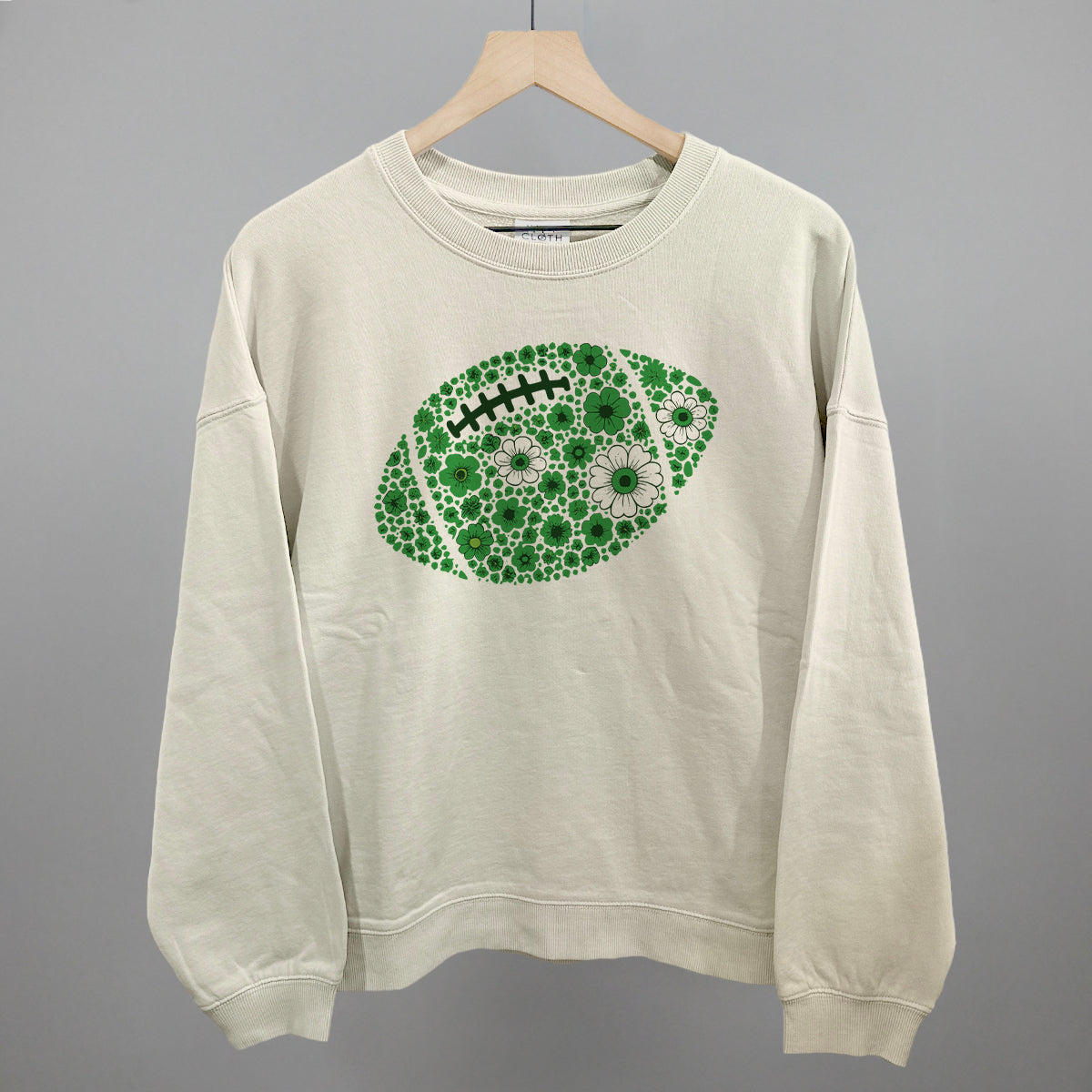 Green floral football design shown in bone