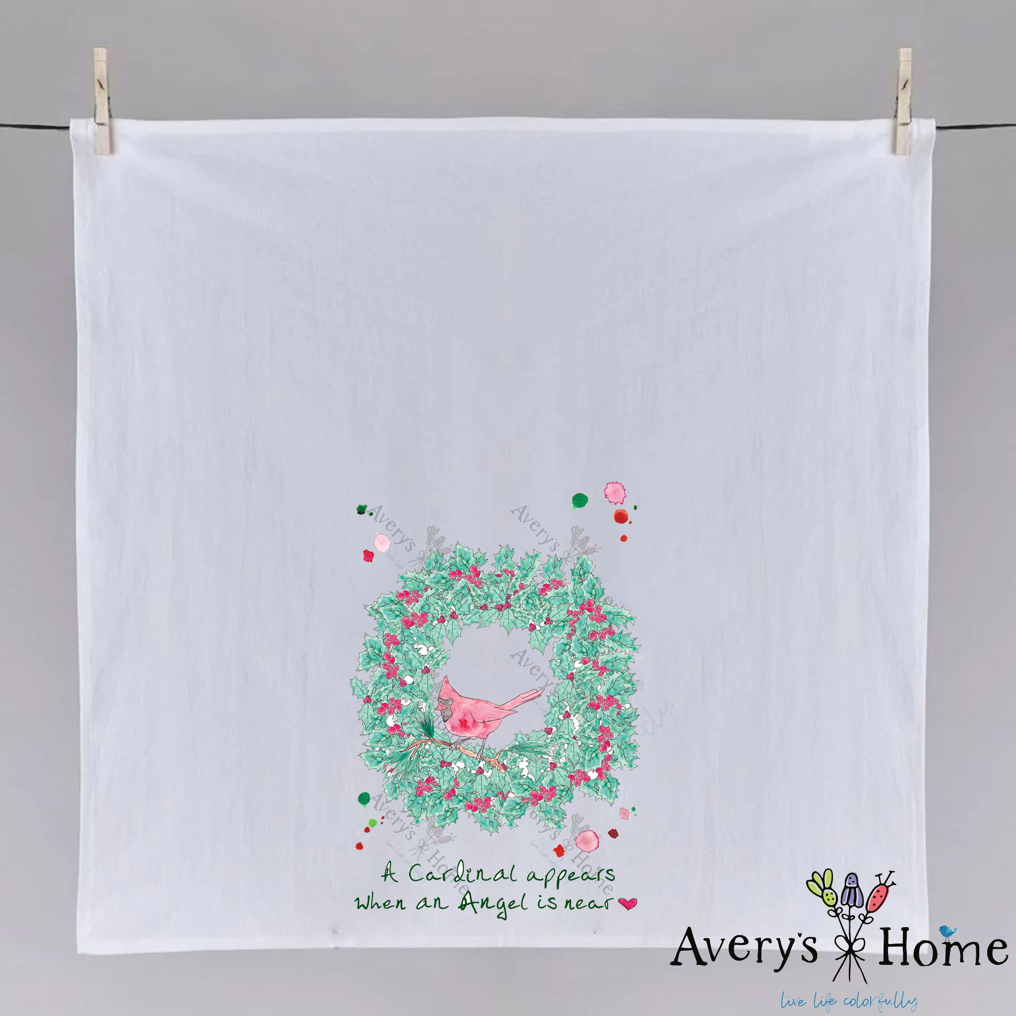 Cardinals Appear Christmas Wreath dish towel hanging in the kitchen