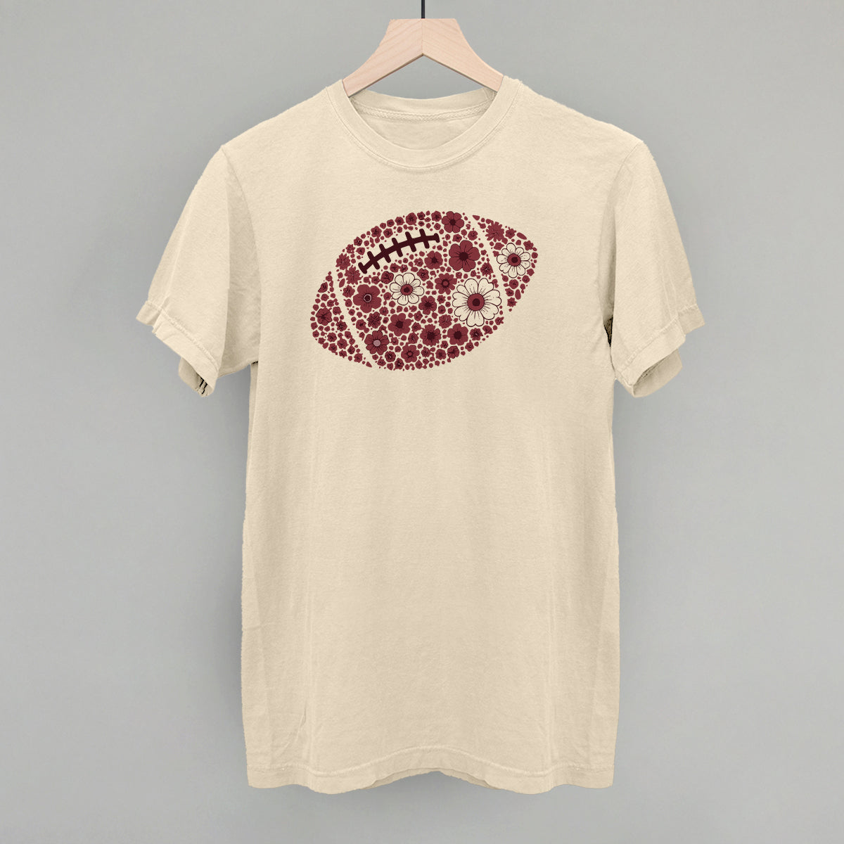 Maroon floral football design on an ivory Comfort Colors tee