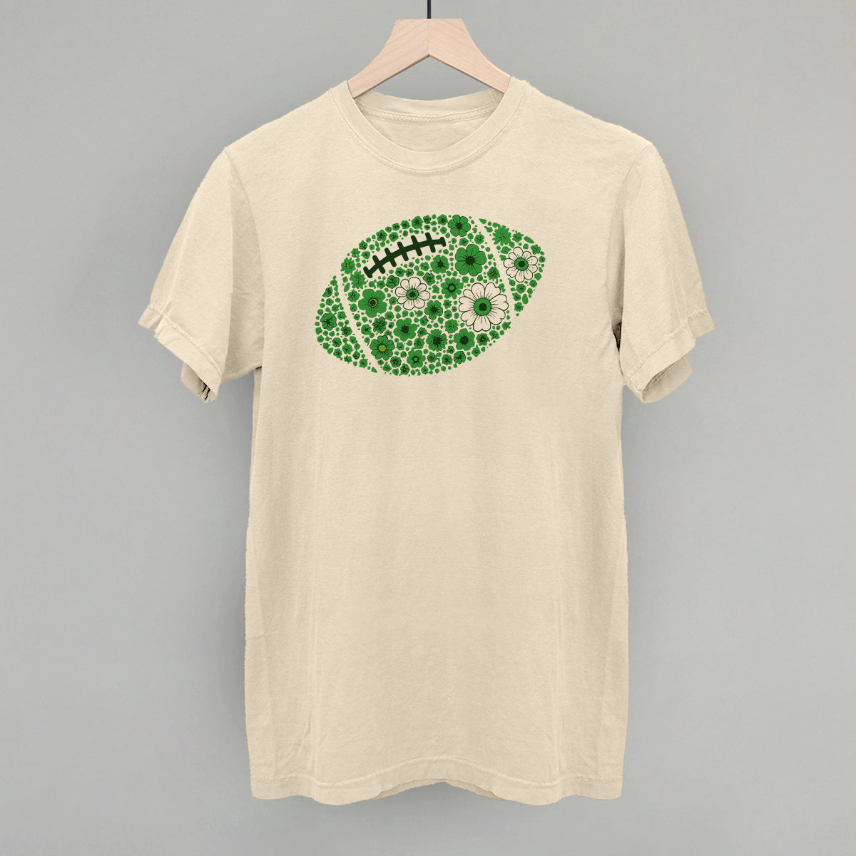 Green floral football design on an ivory Comfort Colors tee