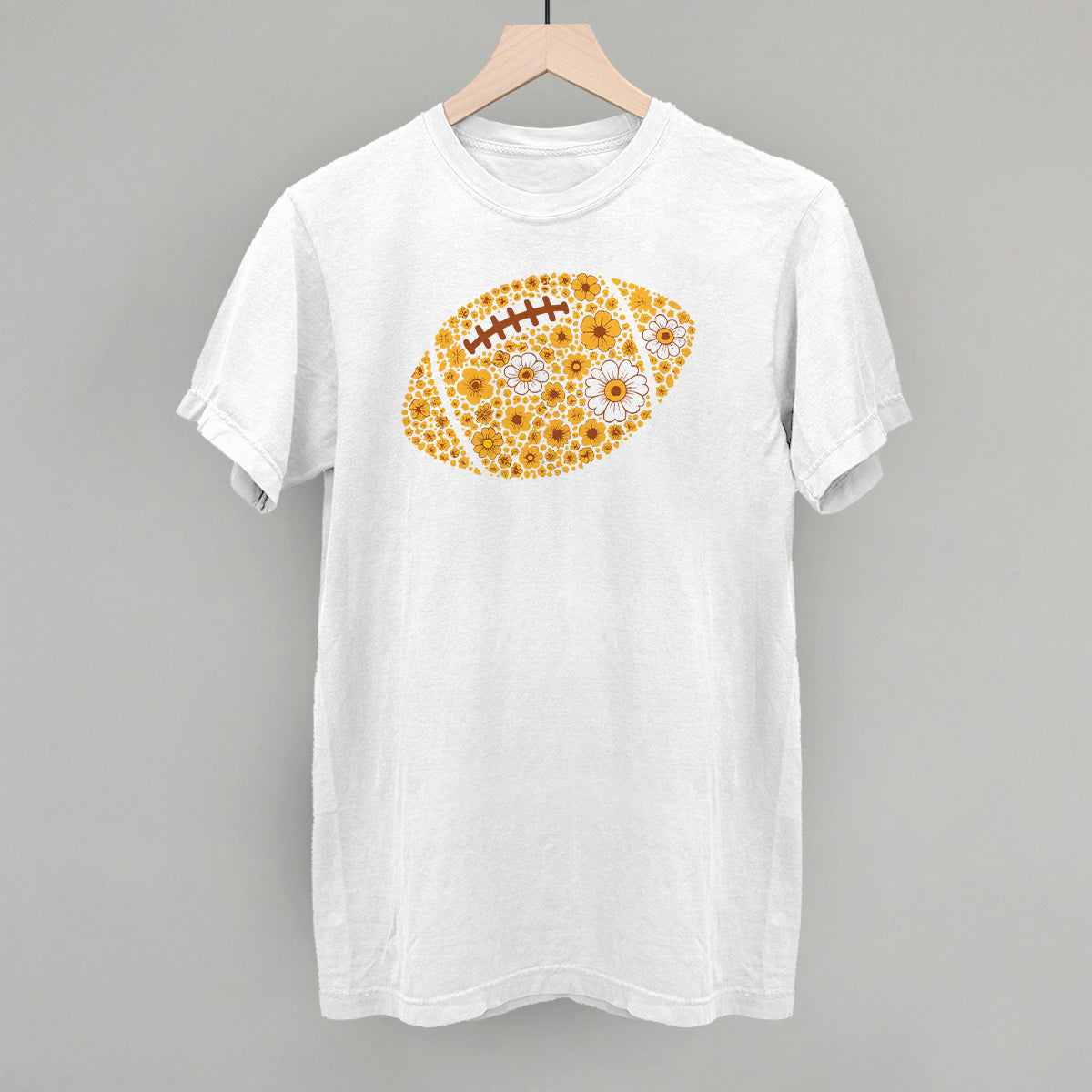 Yellow floral football design on a white Comfort Colors tee