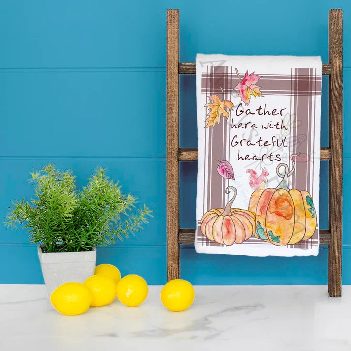 Gather Here dish towel hanging in the kitchen