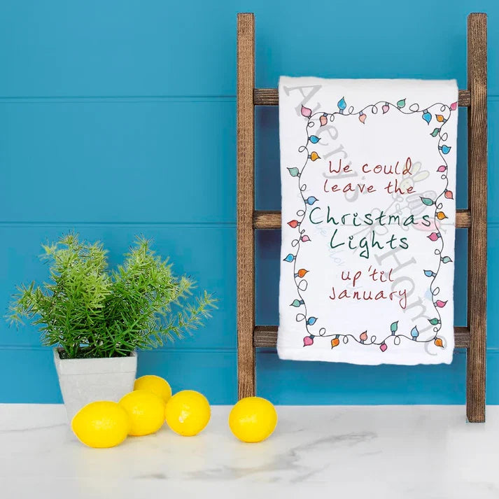 We Could Leave the Lights Up Christmas dish towel hanging in the kitchen