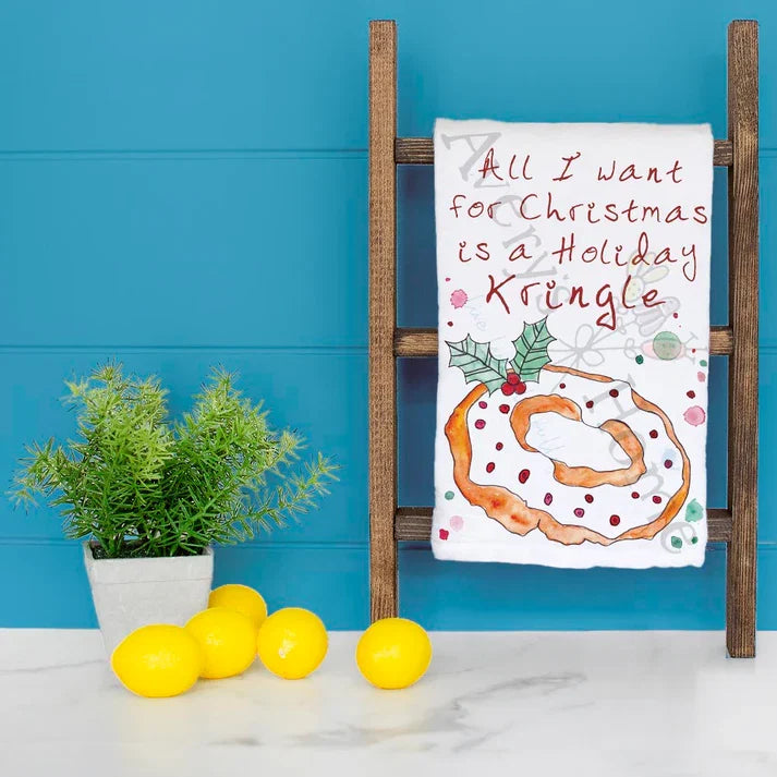 I Want a Holiday Kringle for Christmas dish towel hanging in the kitchen