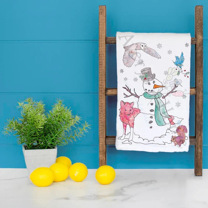 Snowman and Winter Woodland Creatures dish towel hanging in the kitchen