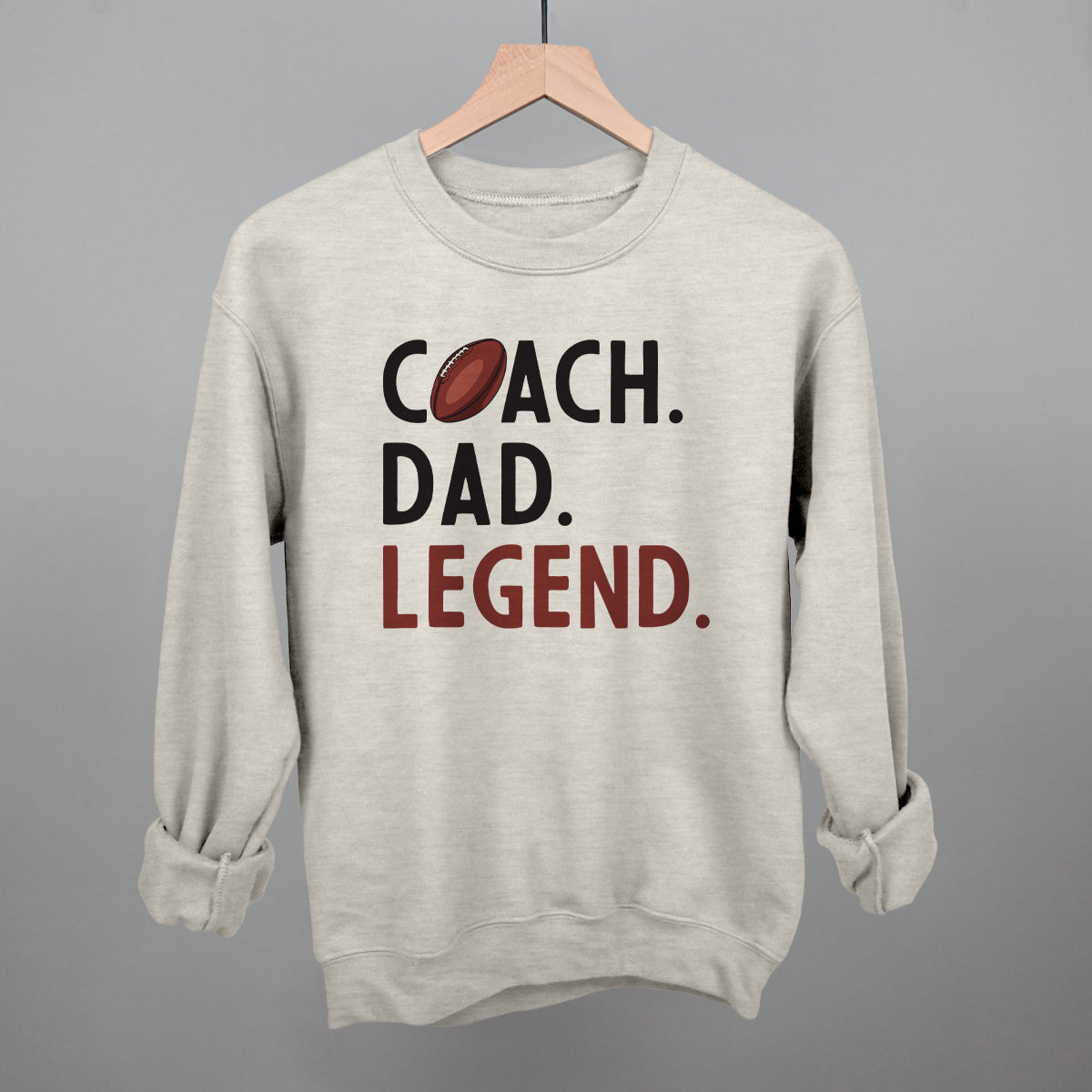 Coach Dad Legend football design on an oatmeal crewneck sweatshirt
