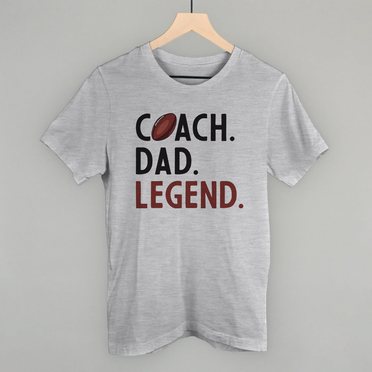 Coach Dad Legend football design on an athletic heather cotton tee