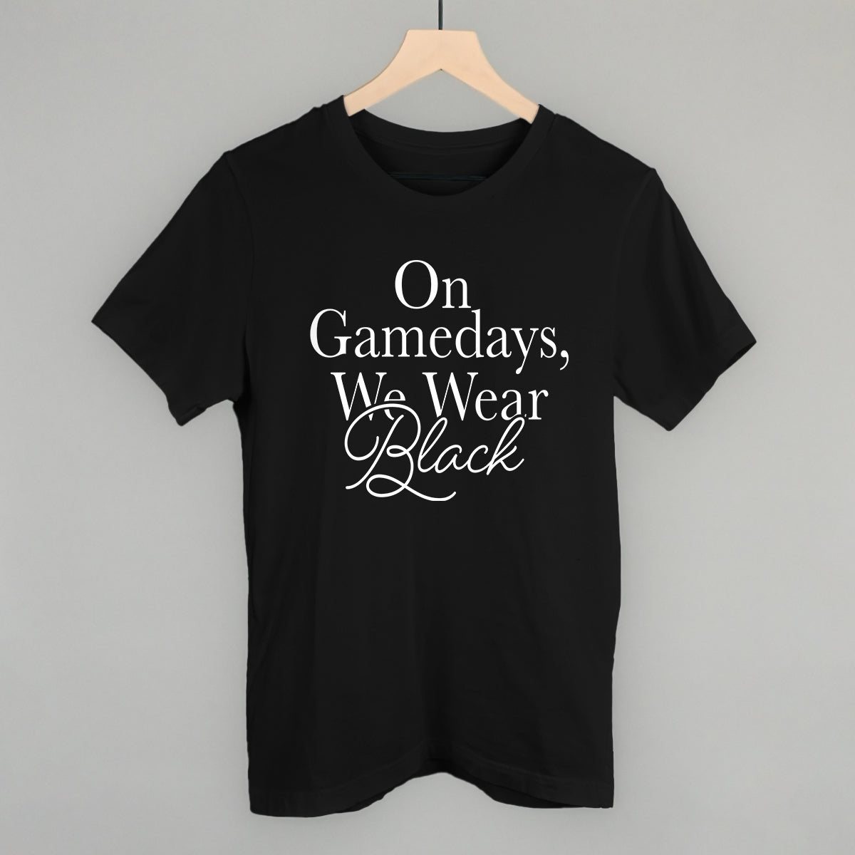 On Game Days We Wear Black design on a black cotton tee