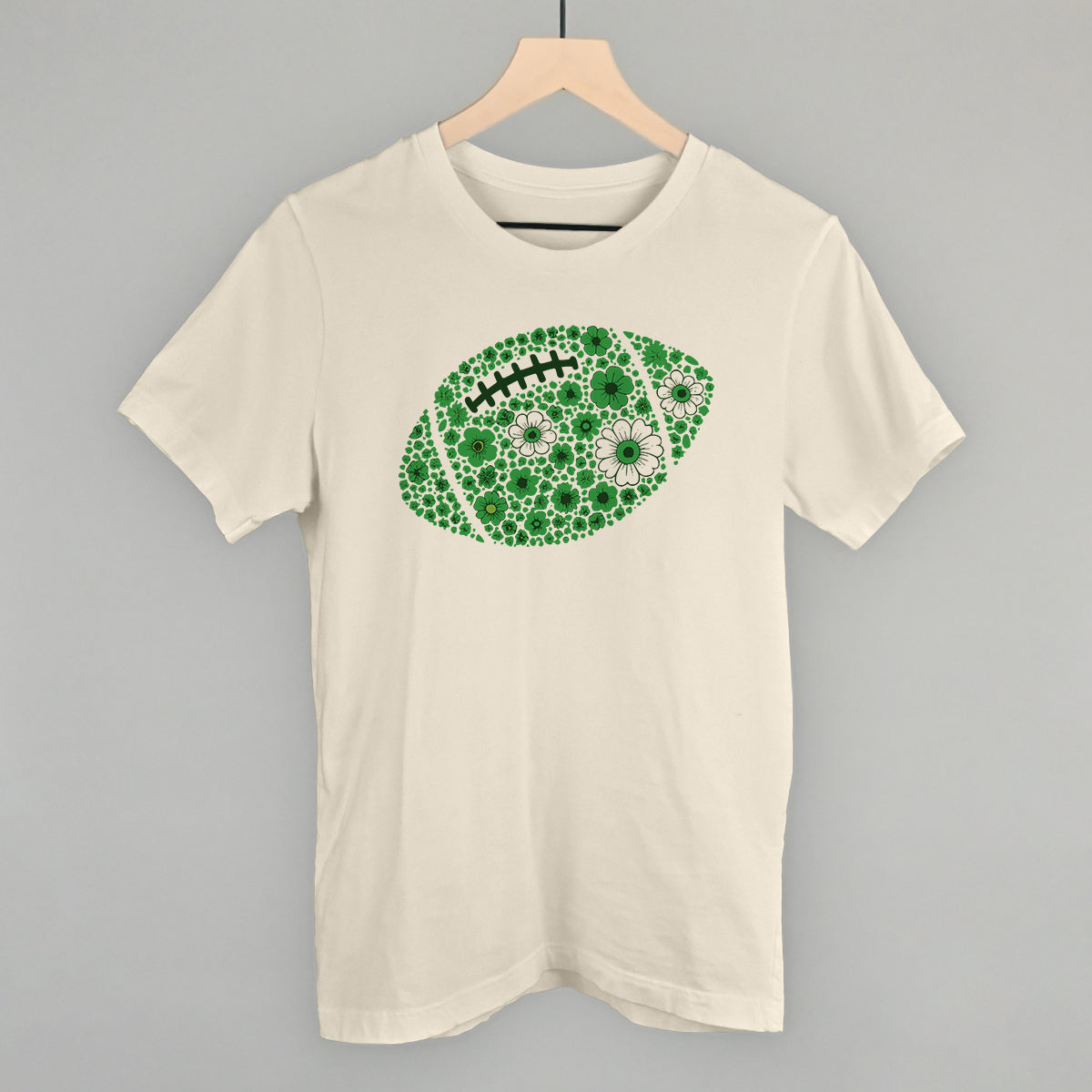 Green floral football design on a natural cotton tee