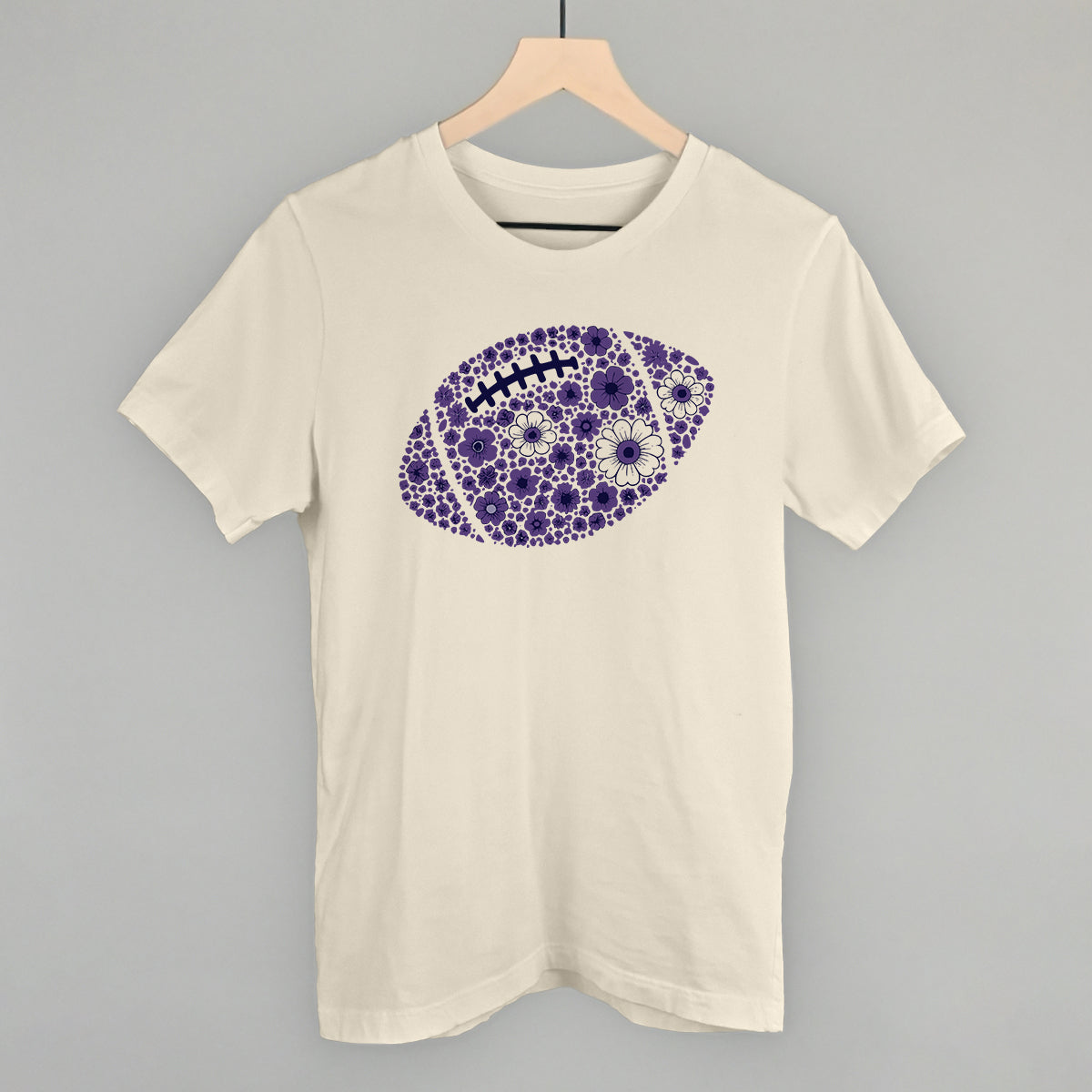 Purple floral football design on a natural cotton tee