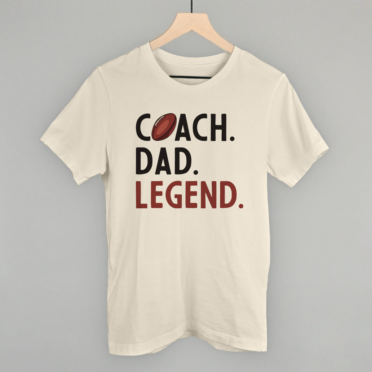 Coach Dad Legend football design on a natural cotton tee