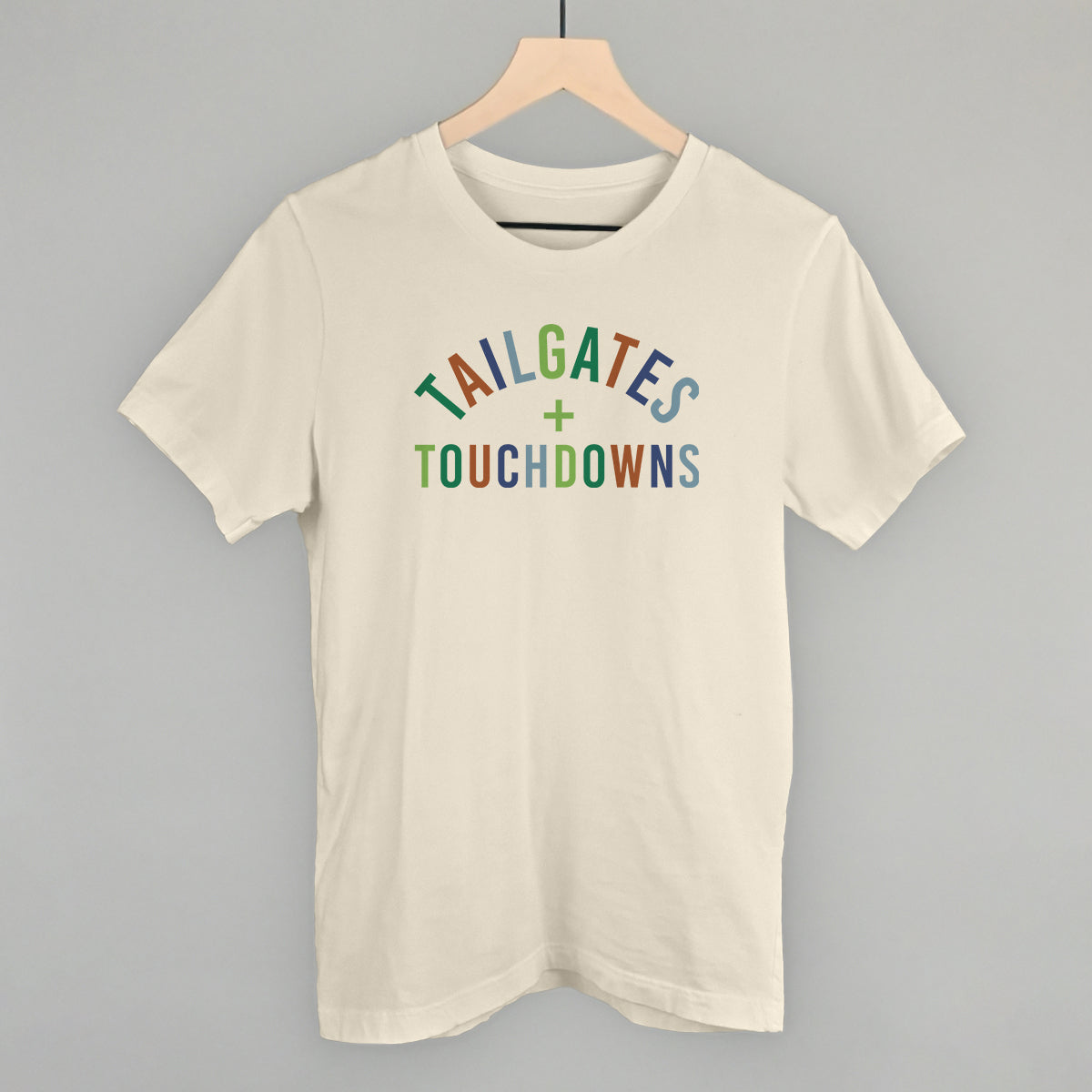 Tailgates And Touchdowns design on a natural cotton tee