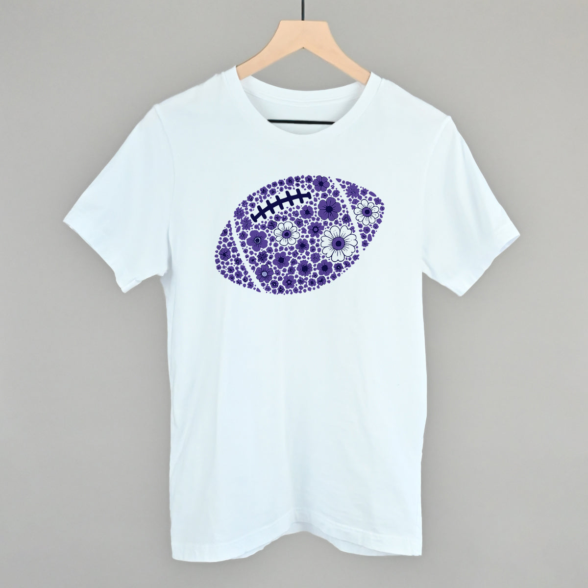 Purple floral football design on a white cotton tee