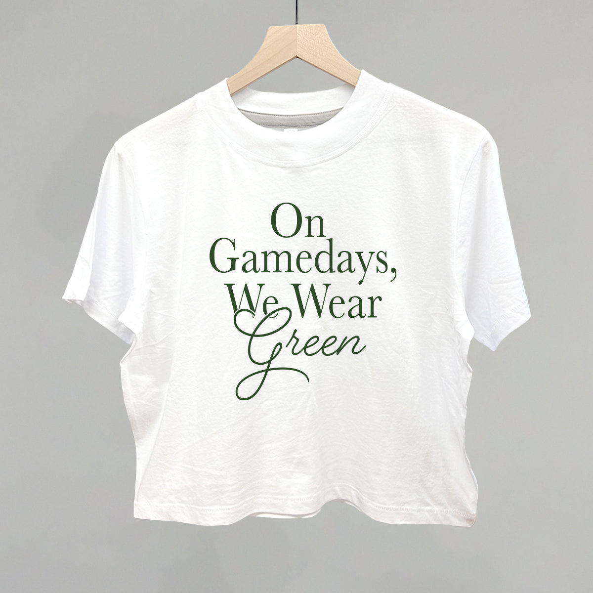 On Gamedays We Wear Green design on a white boxy tee