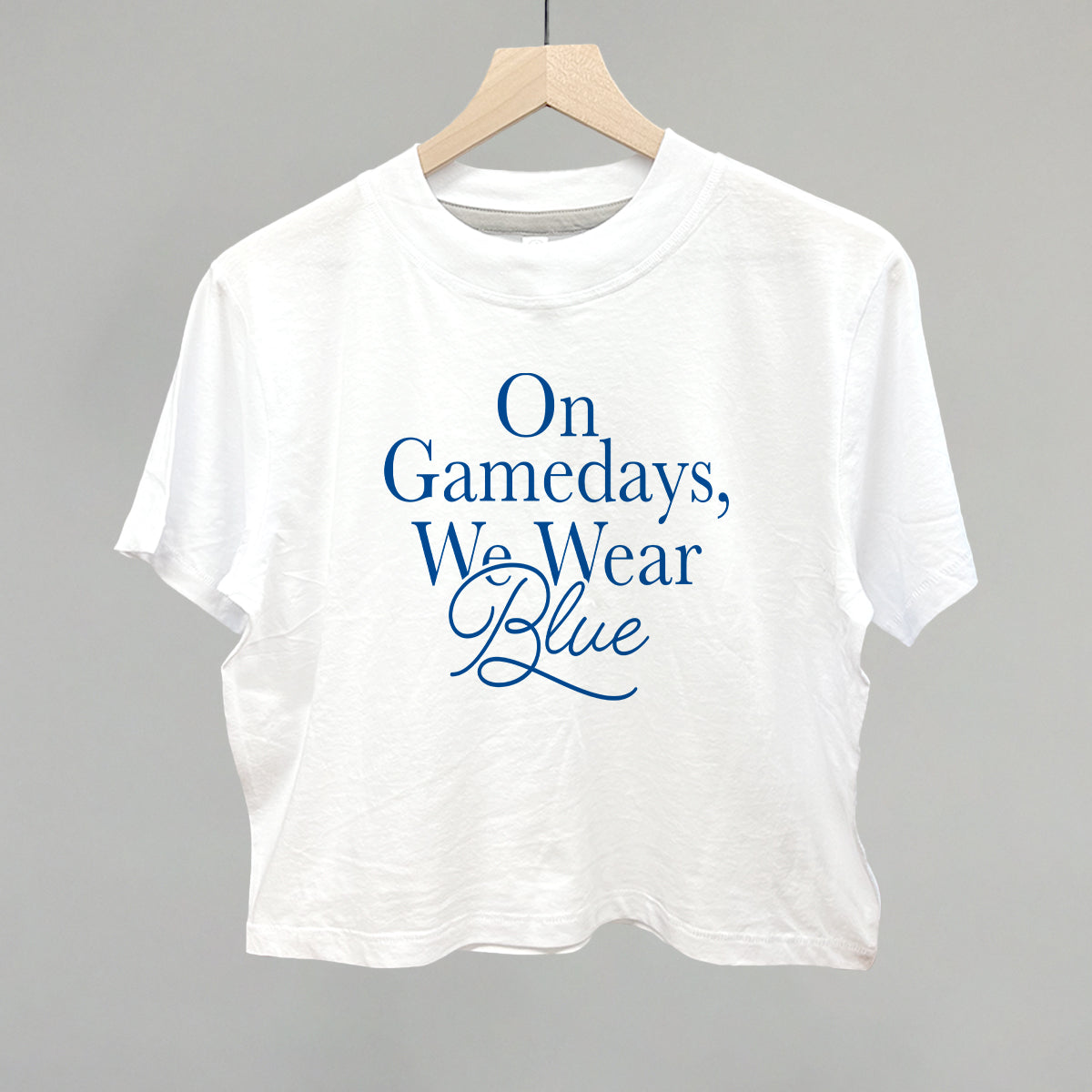 On Gamedays We Wear Blue design on a white boxy tee